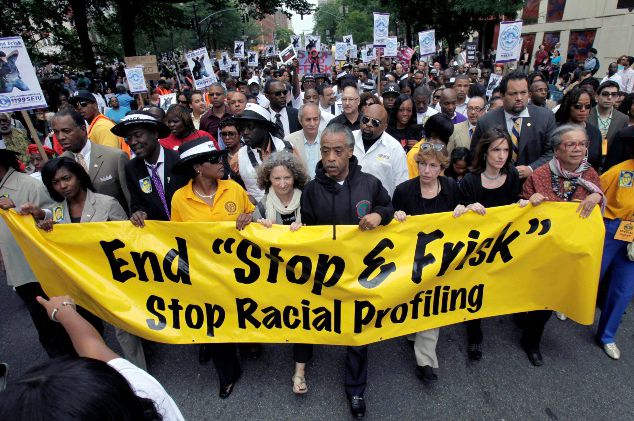 The Rev. Al Sharpton, center, walks with demonstrators during a silent march to end New York's "stop-and-frisk" program in 2012.